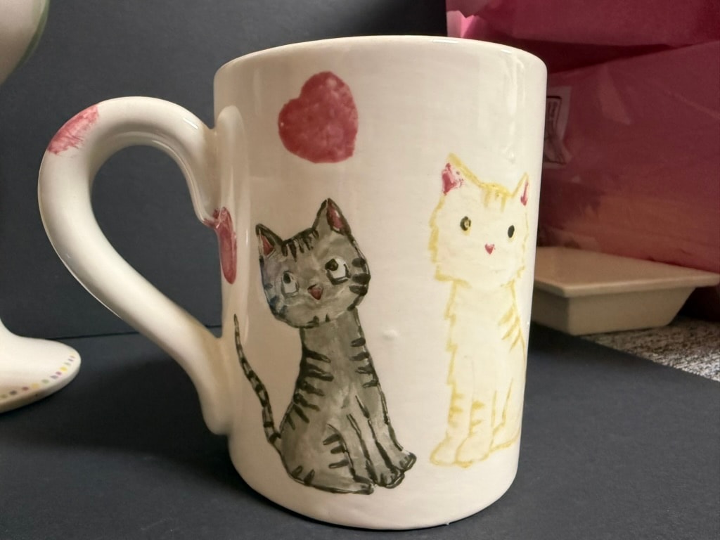 Ceramic mug with illustrated cats and hearts