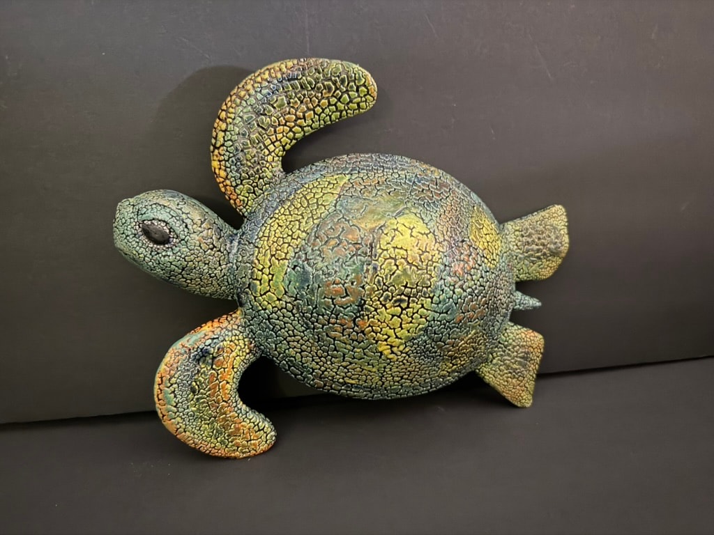 Colorful chameleon figurine overhead view