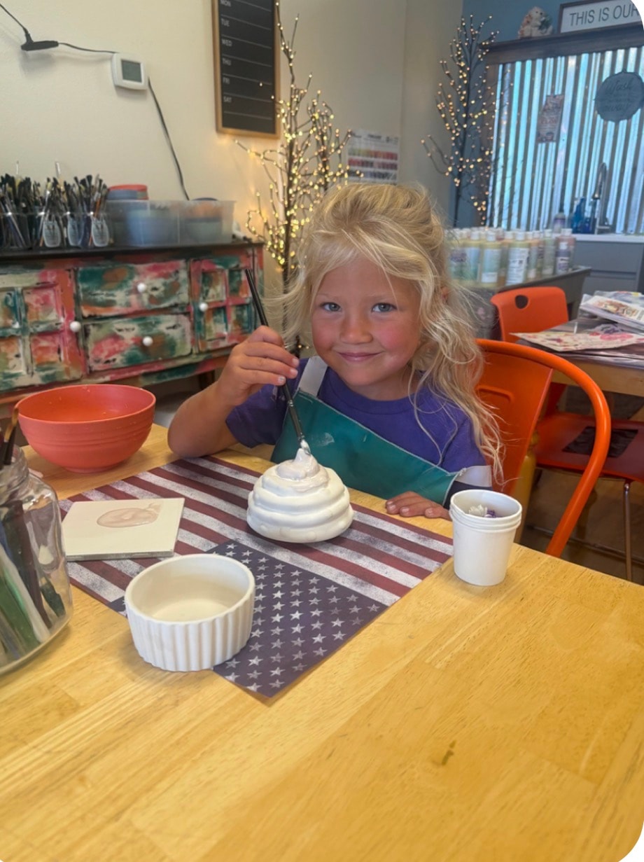 Child decorating a craft project