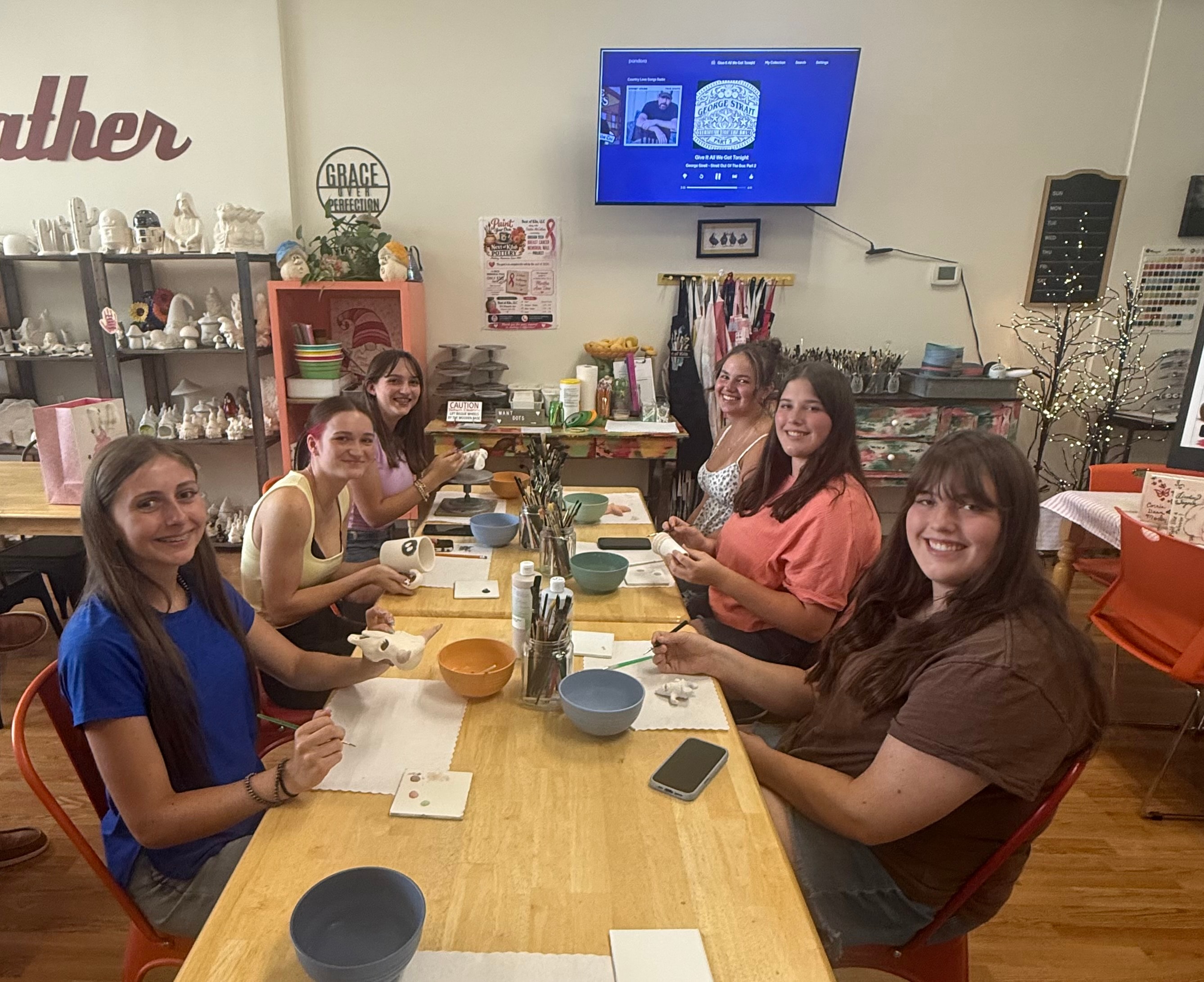 Group of women at pottery studio table